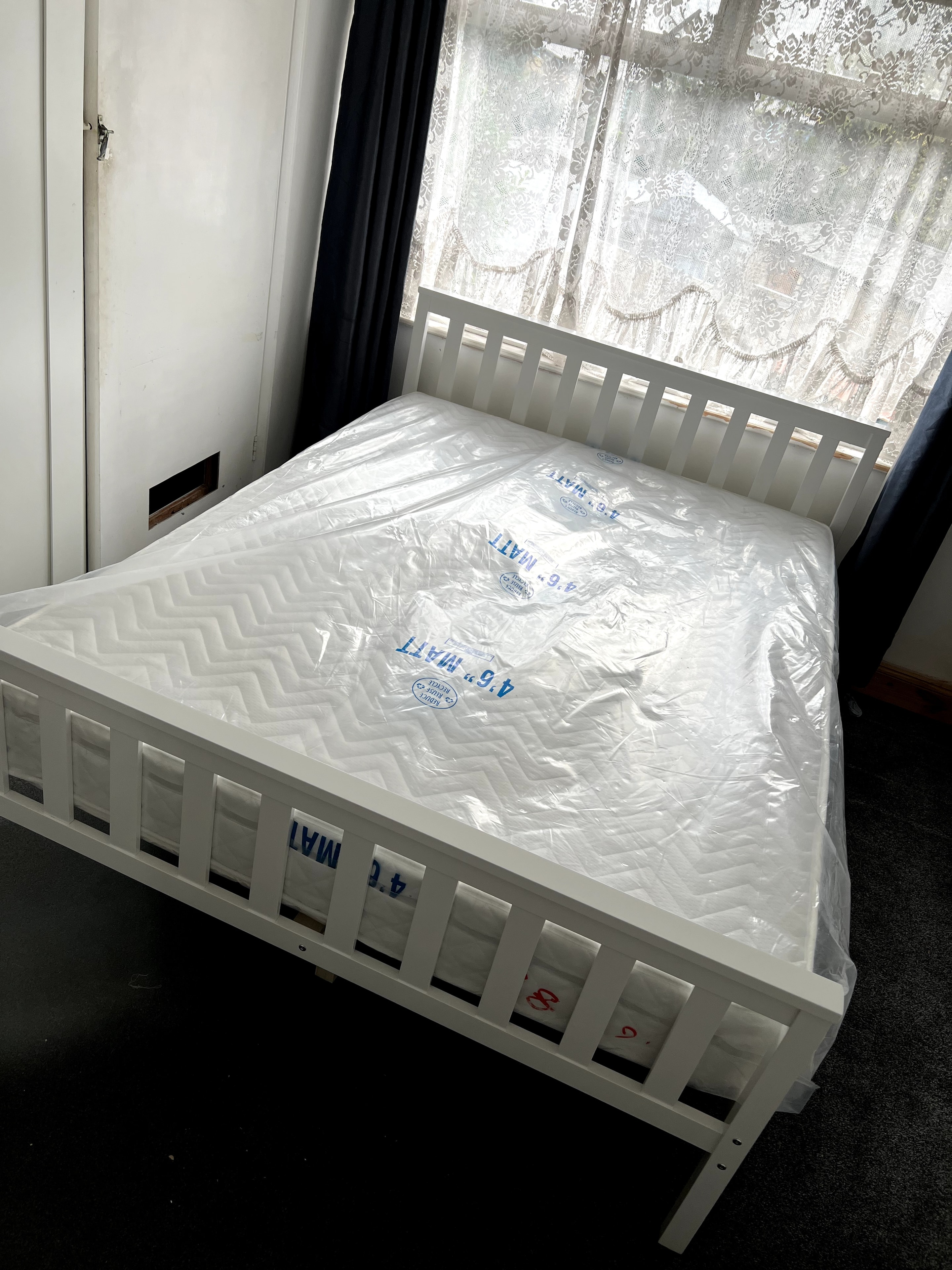 White wooden crib assembled in bedroom