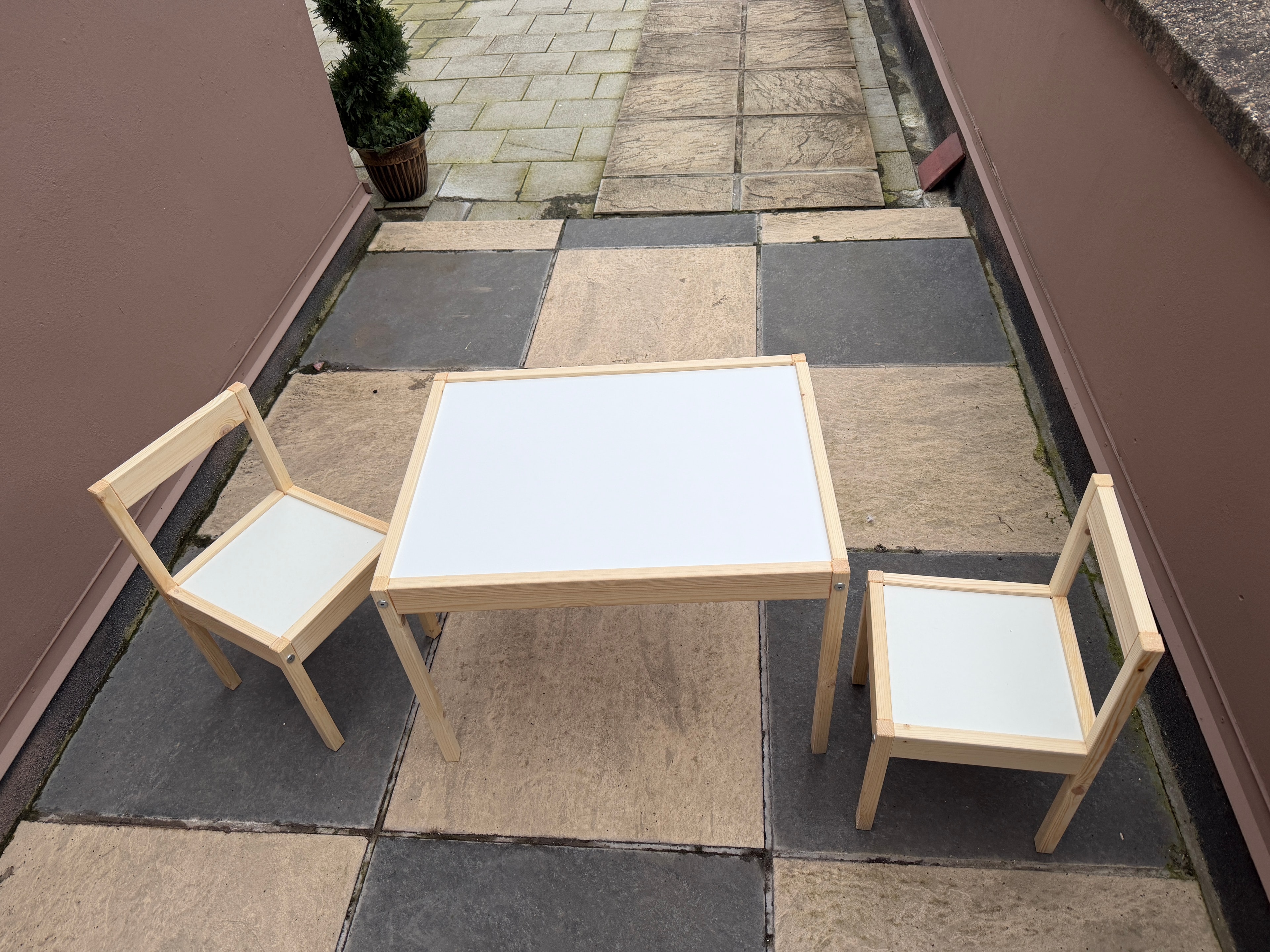 IKEA kids table and two chairs assembled on patio