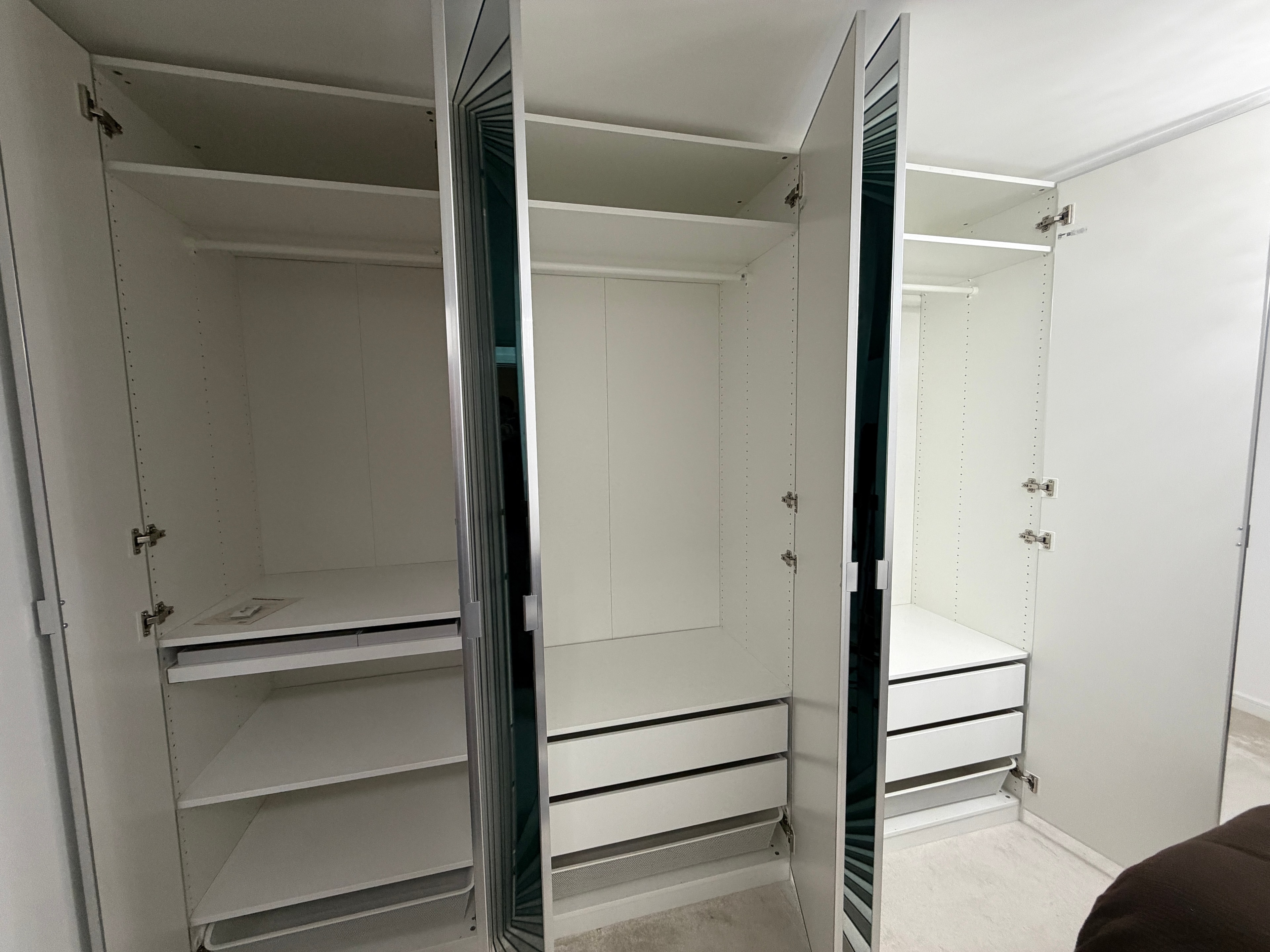 Full-height floor-to-ceiling mirror wardrobe doors assembled in bedroom
