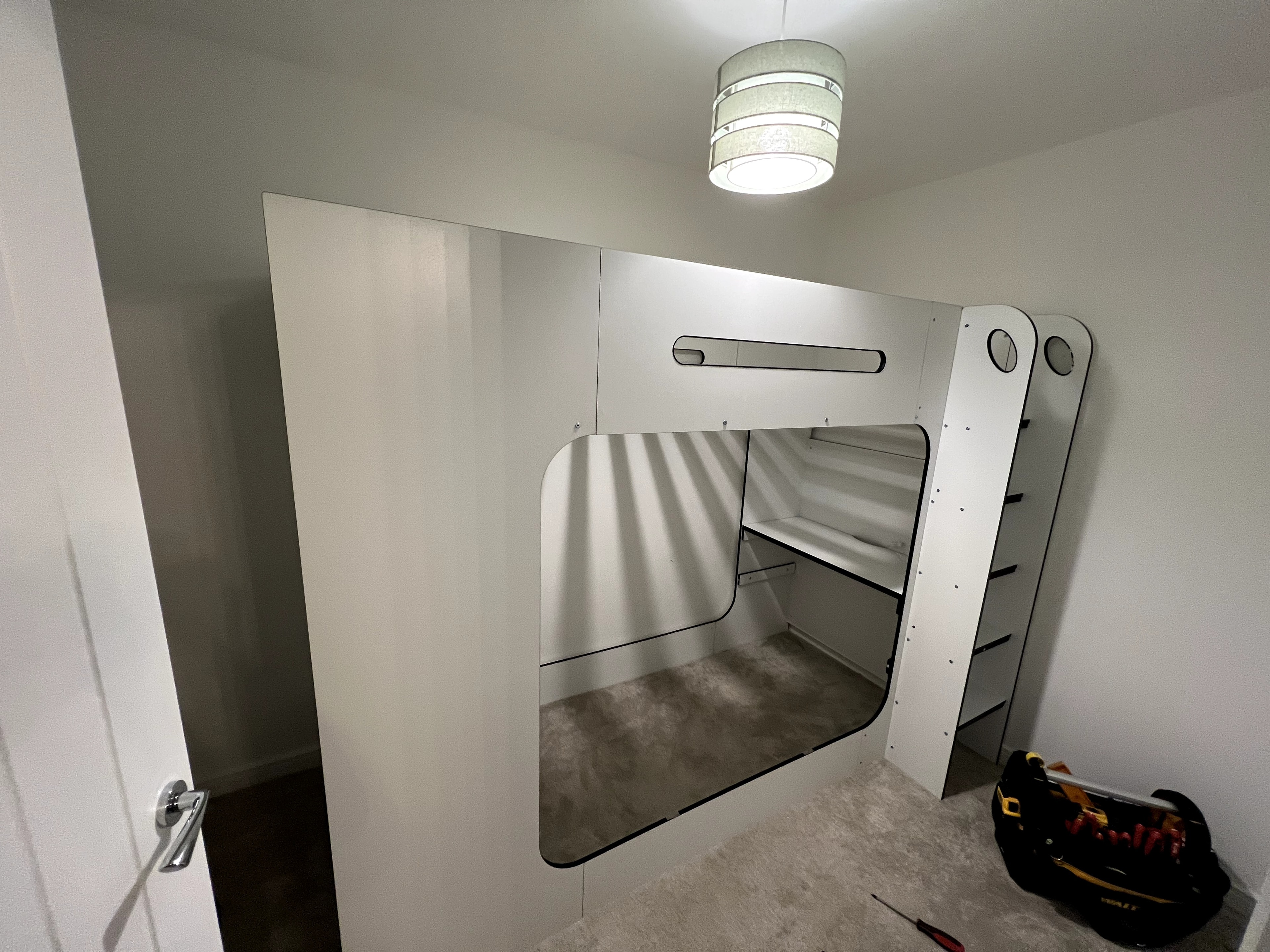 Modern bunk bed with integrated storage drawers and ladder assembled