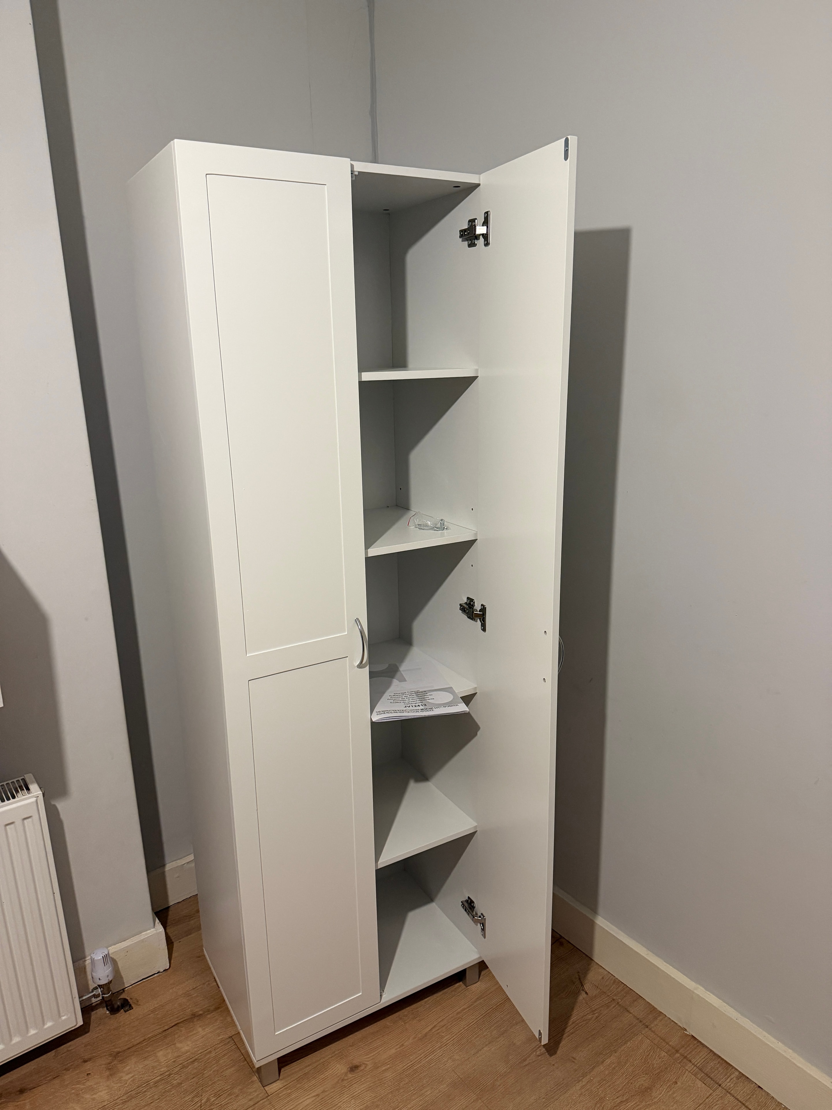 Oak chest of drawers with black handles assembled