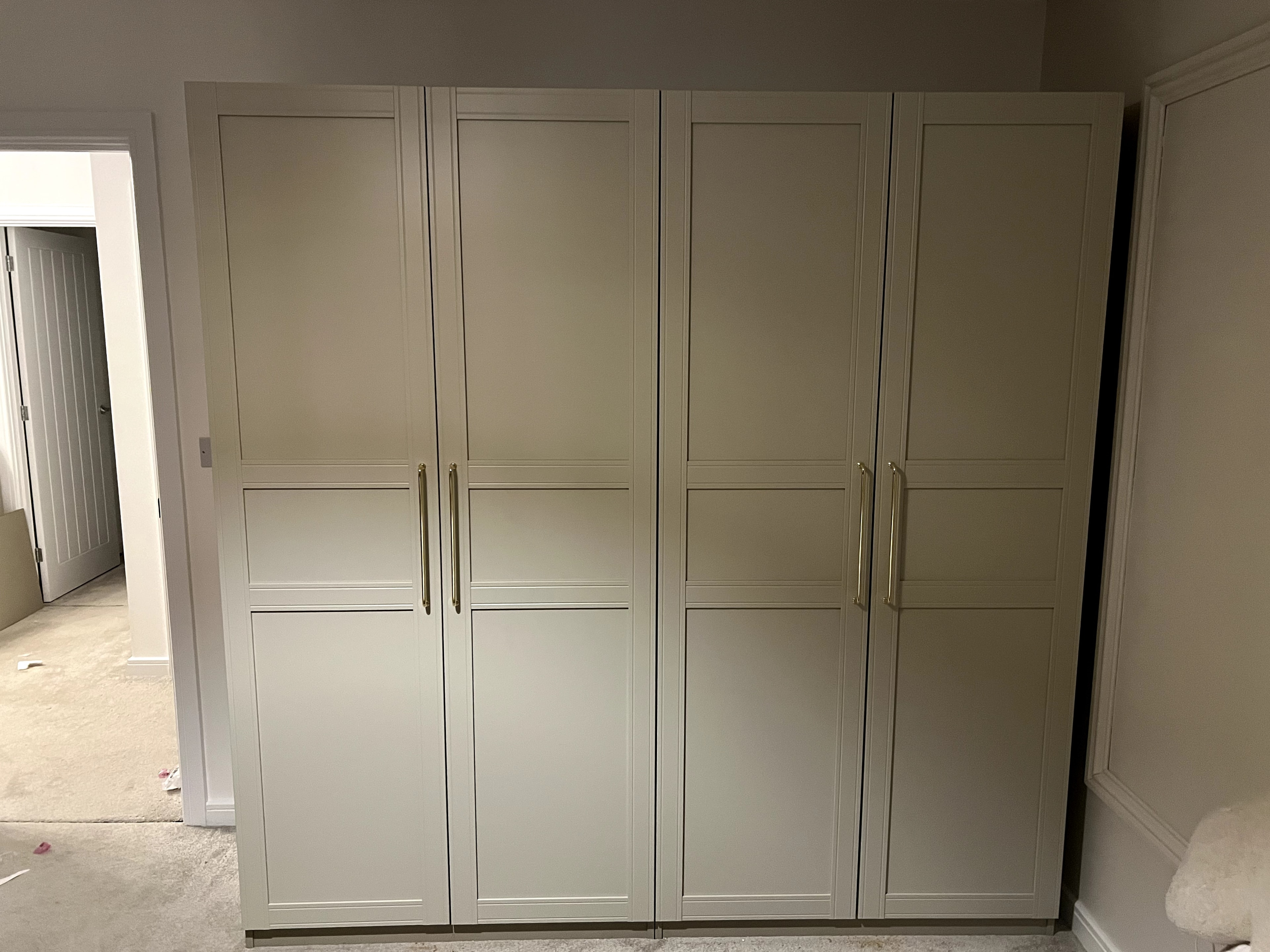 Four-door PAX wardrobe with high-gloss doors fully assembled
