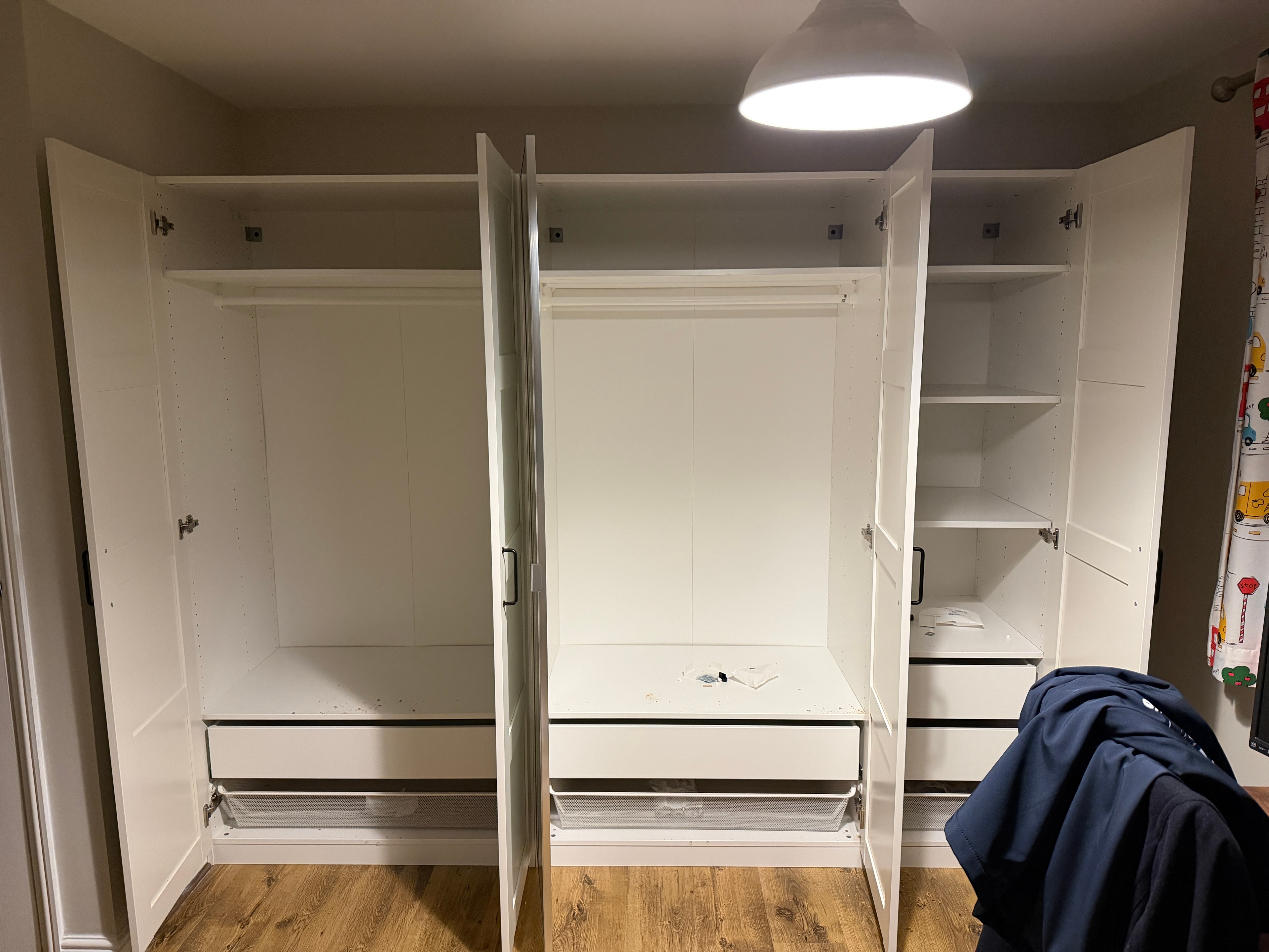 Triple wardrobe with open doors showing interior shelving and hanging rails