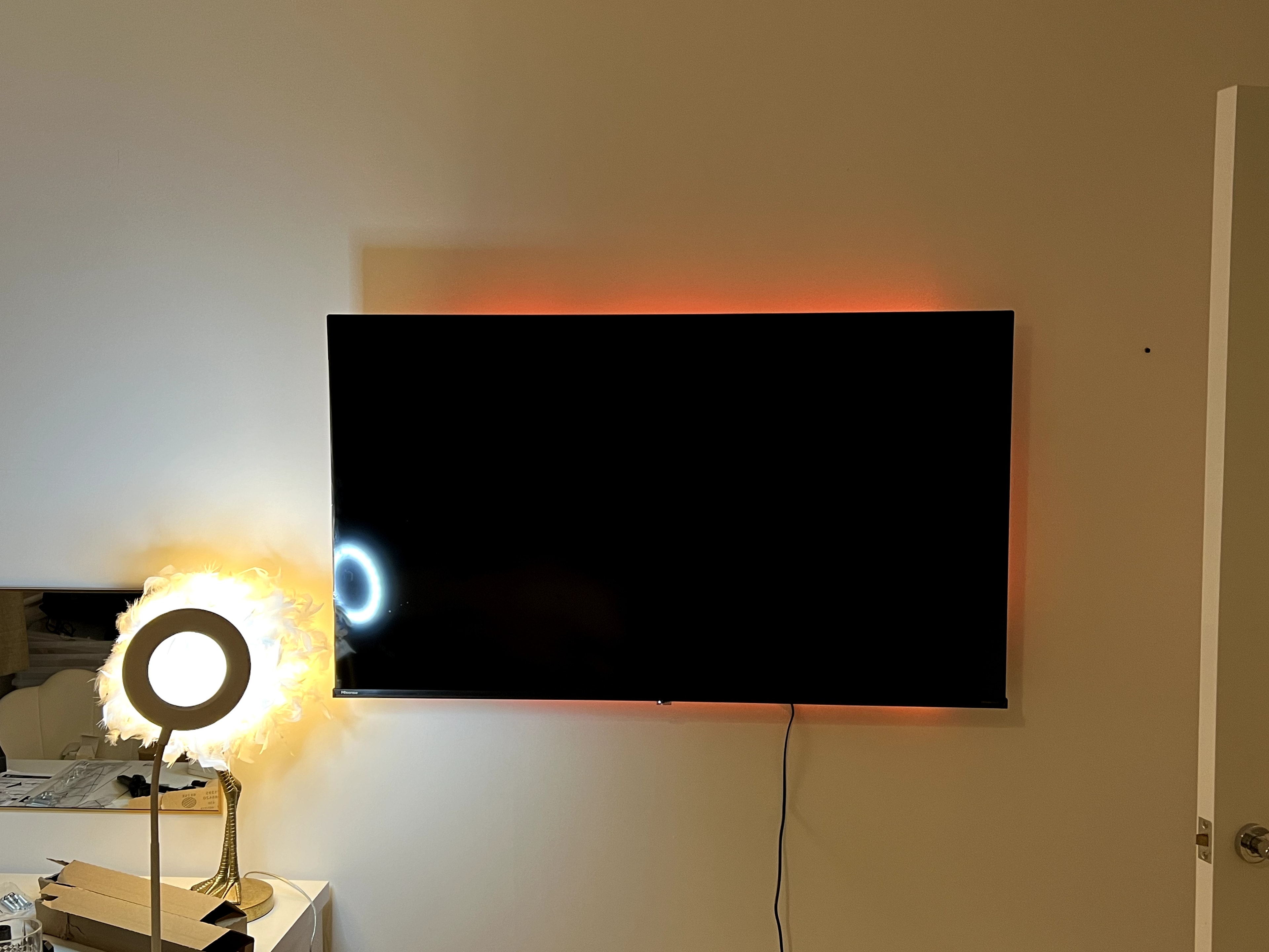 TV wall mounted with ambient backlight in bedroom
